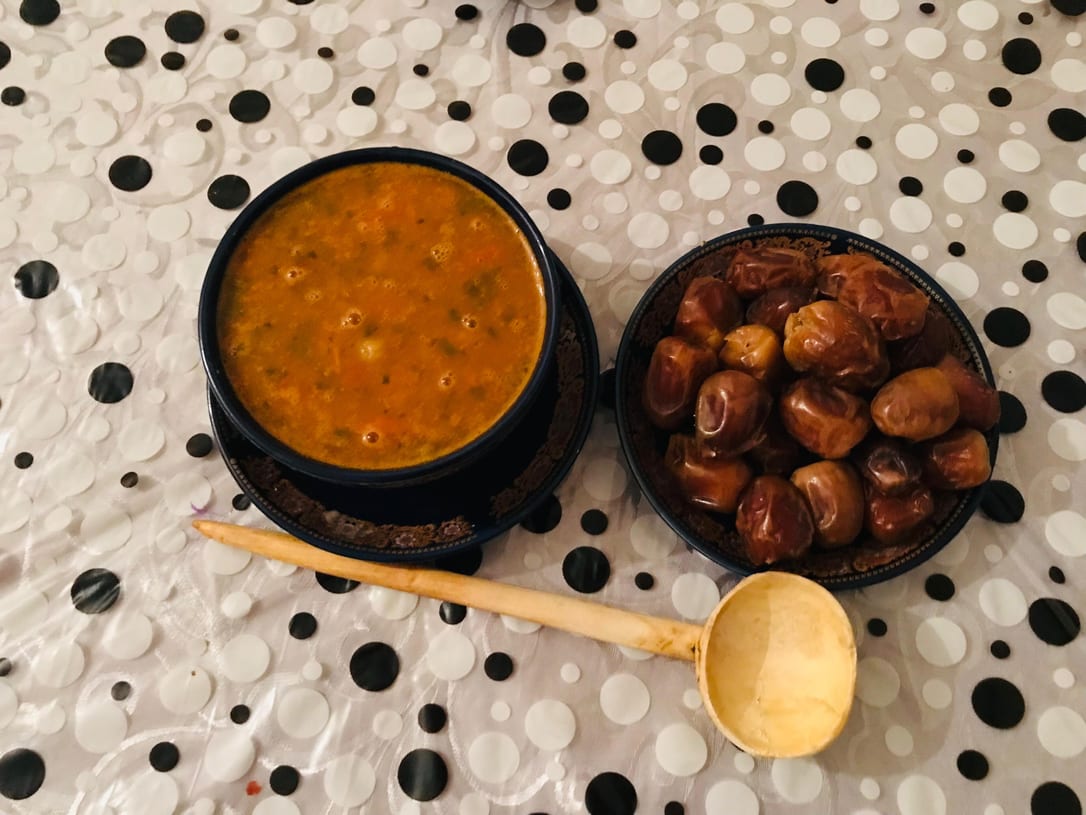 Harira and dates, with a wooden ladle