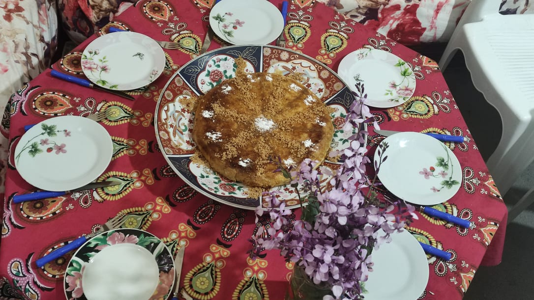 A pastilla in the middle of a laid table, in Fès