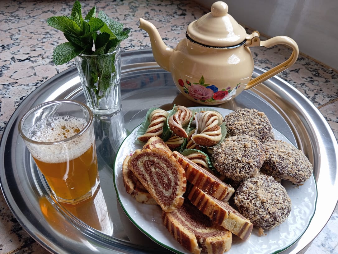 Mint tea and a plate of sweets on a silver tray